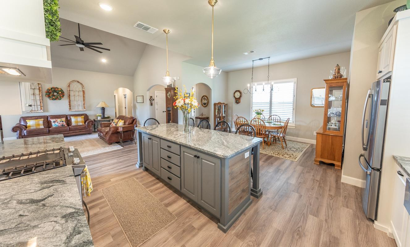 7002 103rd Street Lubbock, TX 79424 - Photo 10 of 28 a large white kitchen with lots of counter space and glass door