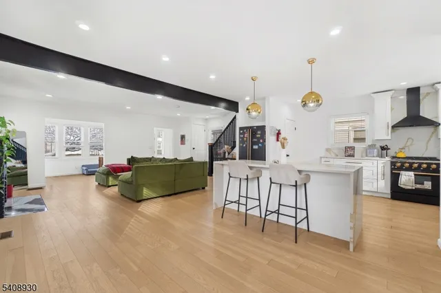 a kitchen with a dining table chairs and white cabinets