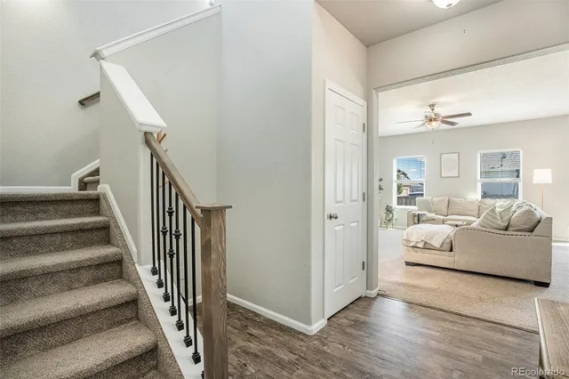 a view of a livingroom with furniture and staircase