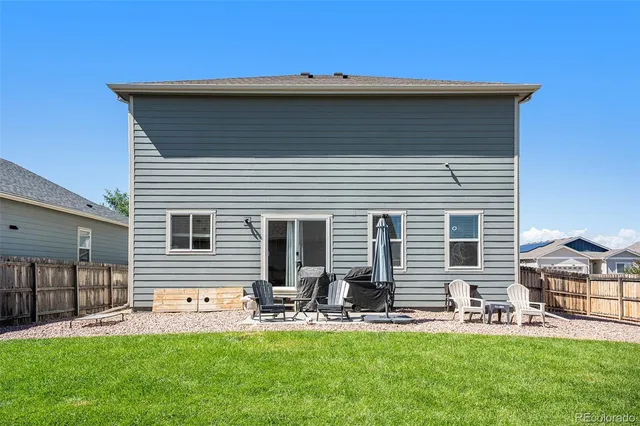 a front view of a house with yard and green space