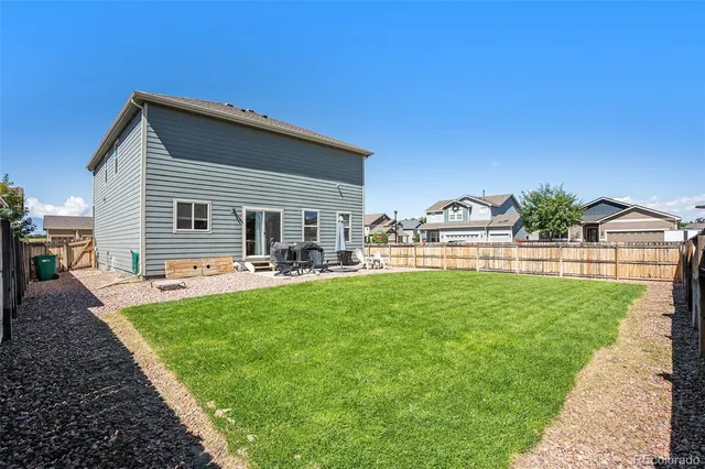 a view of a house with a back yard
