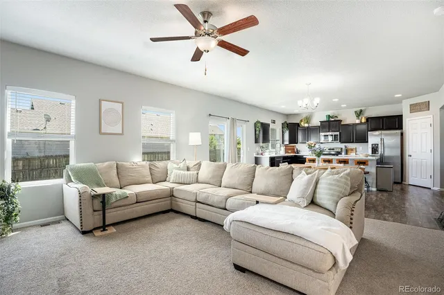 a view of kitchen with kitchen island a sink table and chairs