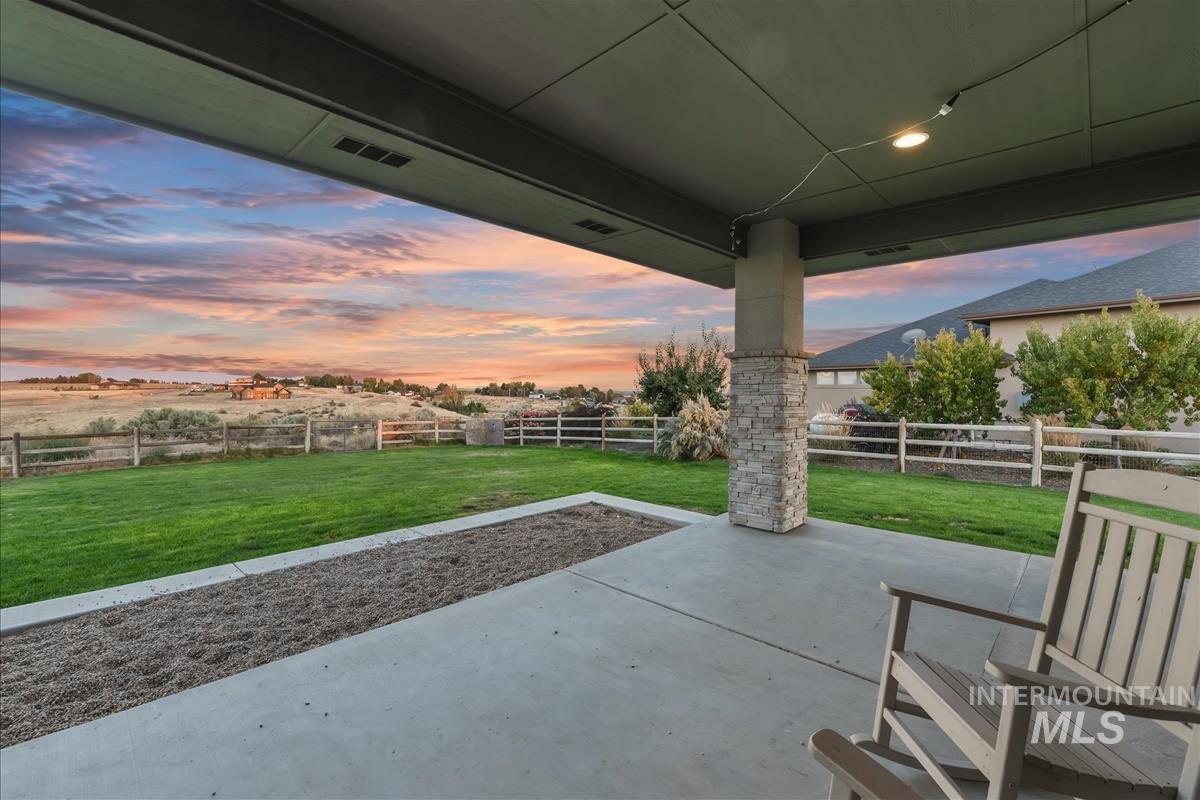 24398 Tombstone Ridge Court Middleton, ID 83644 - Photo 30 of 48 Covered concrete patio with a stone-accented column, recessed lighting, and a fenced backyard