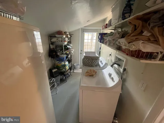 a room with water heater refrigerator washer and dryer