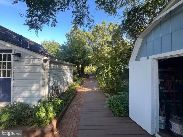 a view of a pathway of a house with a yard
