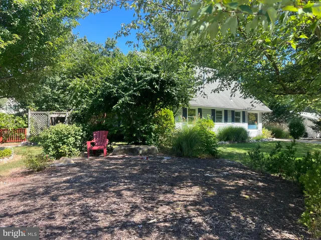 a view of a house with backyard sitting area and garden