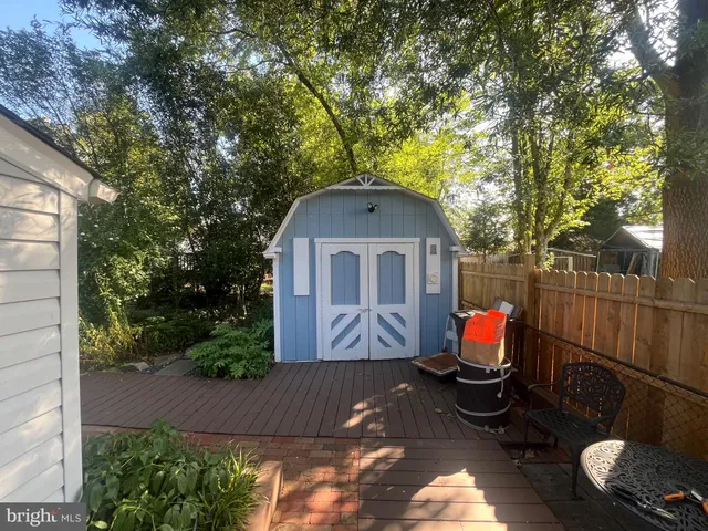 a view of backyard with couches and potted plants
