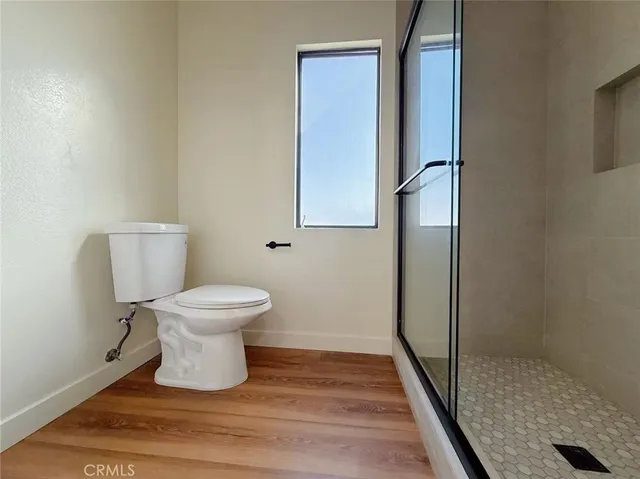 a white toilet sitting next to a bathroom sink