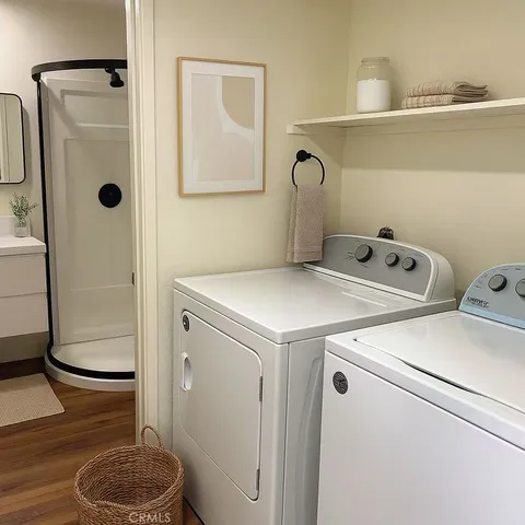 a bathroom with a granite countertop sink and a shower