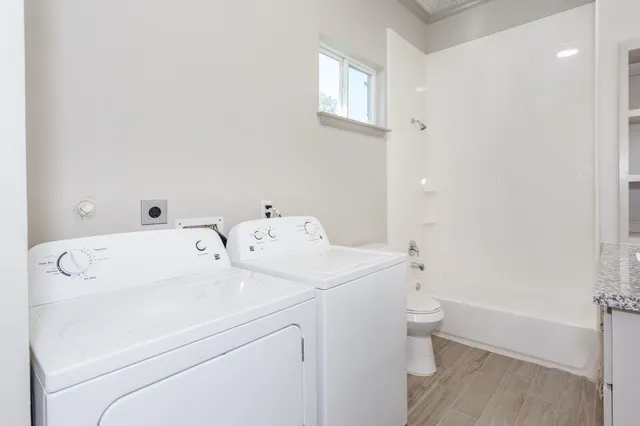 a view of staircase with railing and white walls