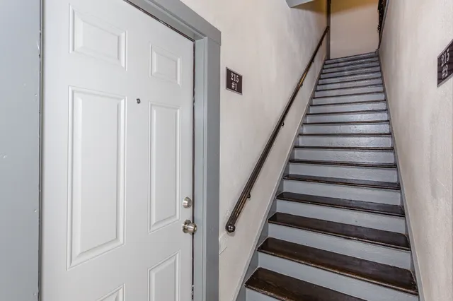 a yellow house with trees in front of it