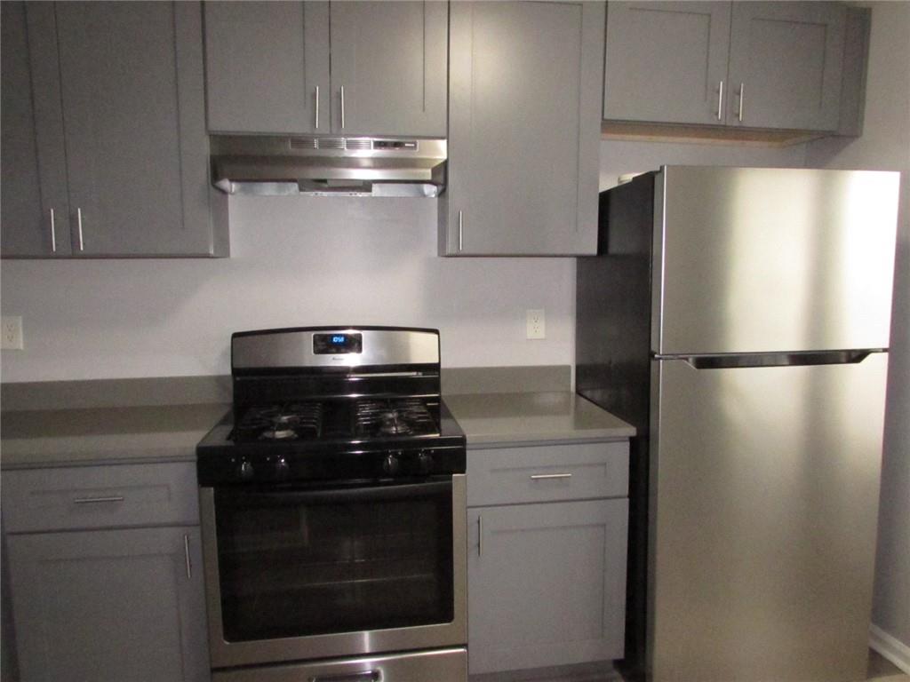 835 Heritage Valley Road Norcross, GA 30093 - Photo 5 of 34 a kitchen with stainless steel appliances wooden cabinets and a stove