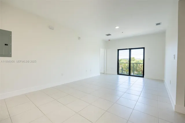 a view of an empty room with glass door
