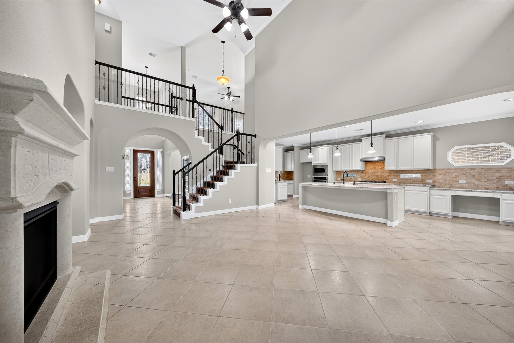 6234 Avon Landing Lane Spring, TX 77379 - Photo 48 of 49 The open floorplan of the family room is flooded with natural light from the large windows and cooled by a ceiling fan, this room feels expansive and open with access to the kitchen.