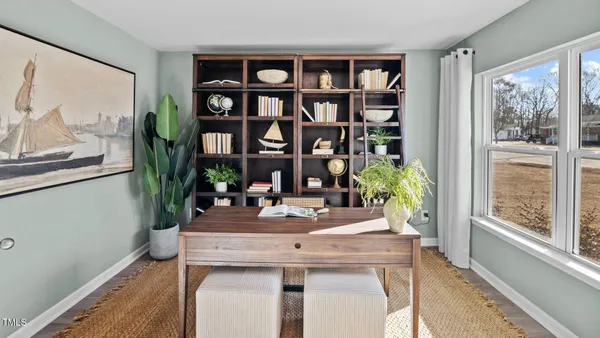 a view of a dining room with furniture and a potted plant