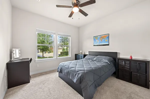 a bedroom with a bed and a chandelier