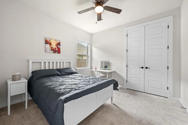 a bathroom with a granite countertop toilet sink and mirror