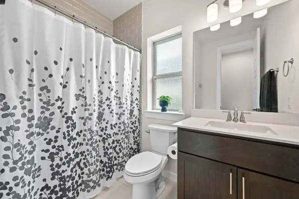 a bedroom with a bed and a potted plant