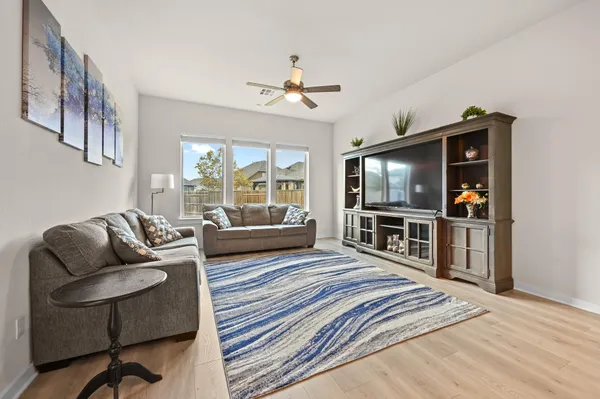 a living room with furniture and kitchen view