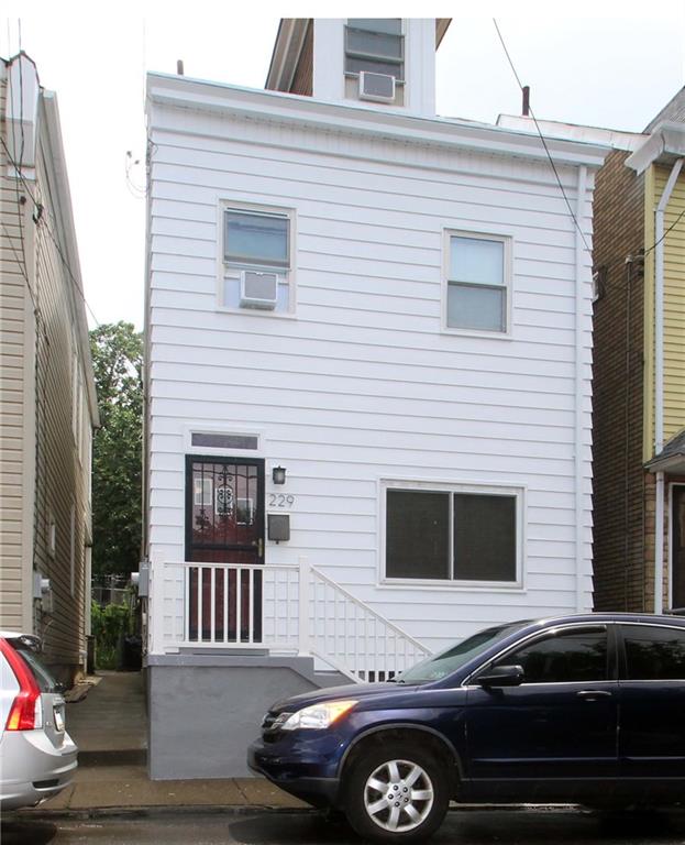 229 Edmond Street Pittsburgh, PA 15224 - Photo 1 of 22 a front view of a house with parking space
