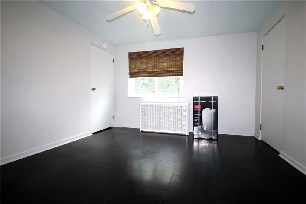 229 Edmond Street Pittsburgh, PA 15224 - Photo 16 of 22 a view of an empty room with wooden floor and a window