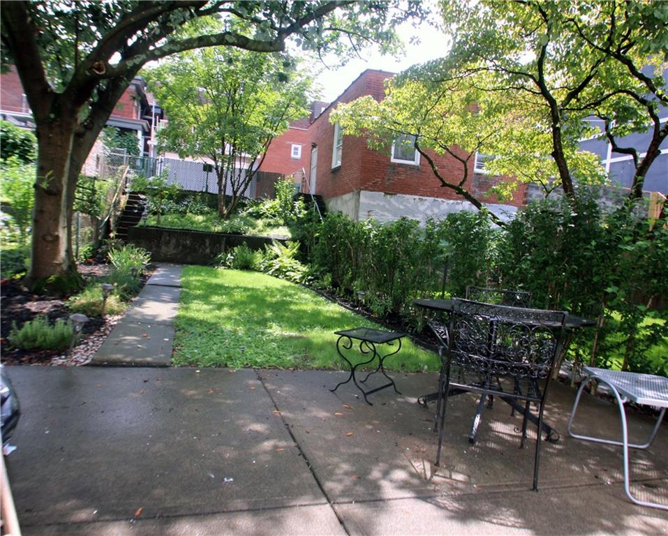 229 Edmond Street Pittsburgh, PA 15224 - Photo 21 of 22 a backyard of a house with yard and trampoline