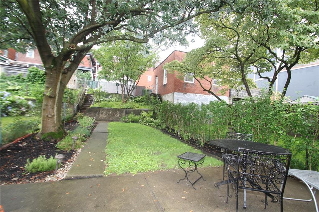 229 Edmond Street Pittsburgh, PA 15224 - Photo 22 of 22 a view of backyard with table and chairs and a large tree