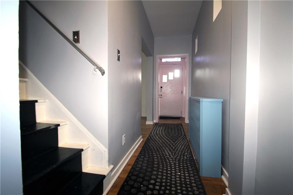 229 Edmond Street Pittsburgh, PA 15224 - Photo 4 of 22 a view of a hallway with wooden floor and staircase