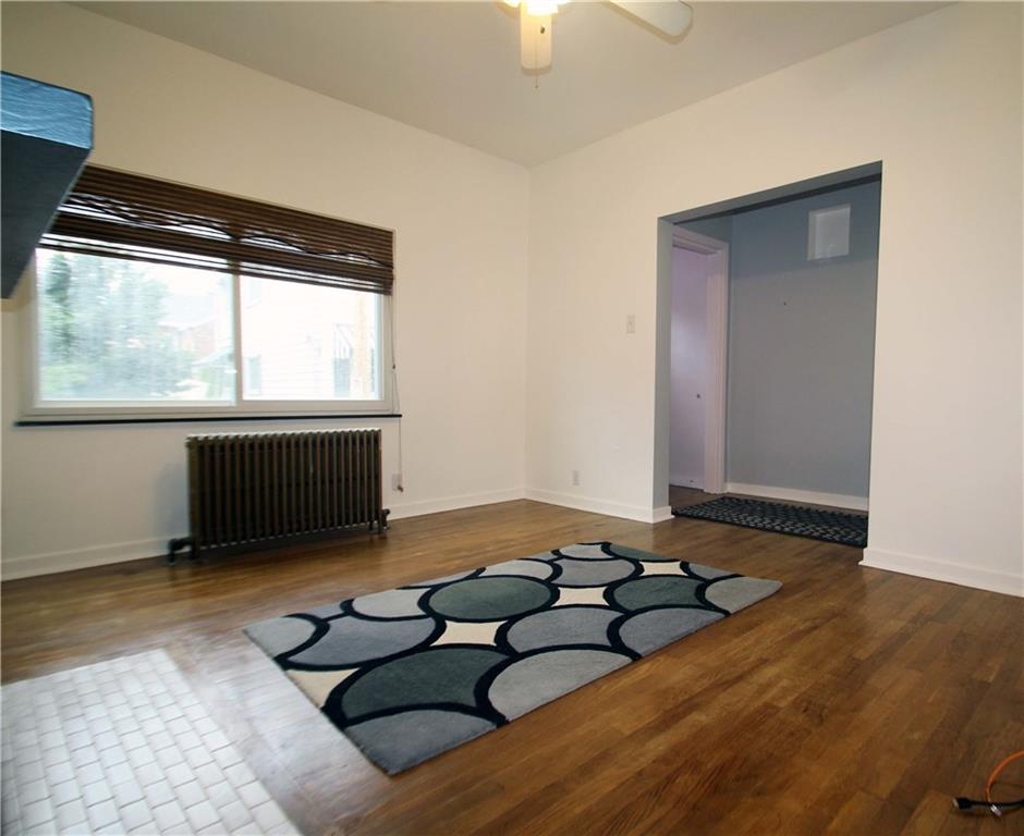 229 Edmond Street Pittsburgh, PA 15224 - Photo 8 of 22 a living room with furniture and a flat screen tv
