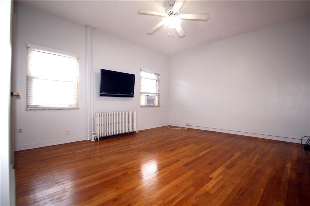 229 Edmond Street Pittsburgh, PA 15224 - Photo 10 of 22 a view of an empty room with wooden floor and a window