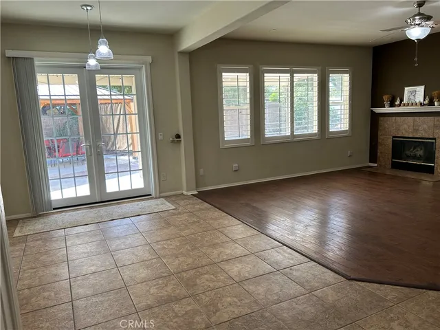 an empty room with windows and fireplace