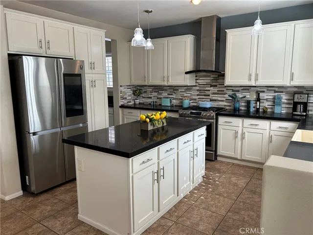 a kitchen with granite countertop a white cabinets a sink and stainless steel appliances