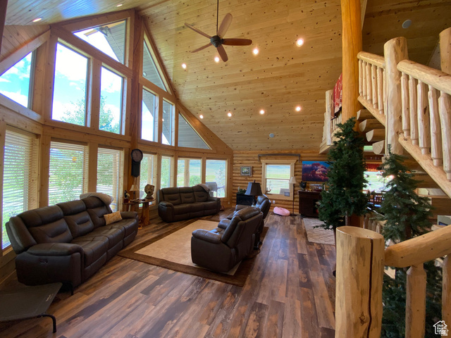 79 Auburn Forest Road Auburn, WY 83111 - Photo 15 of 76 Living room with log walls, ceiling fan, a vaulted wood ceiling, dark wood-type flooring, and recessed lighting