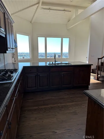 a kitchen with wooden floors and a black appliances