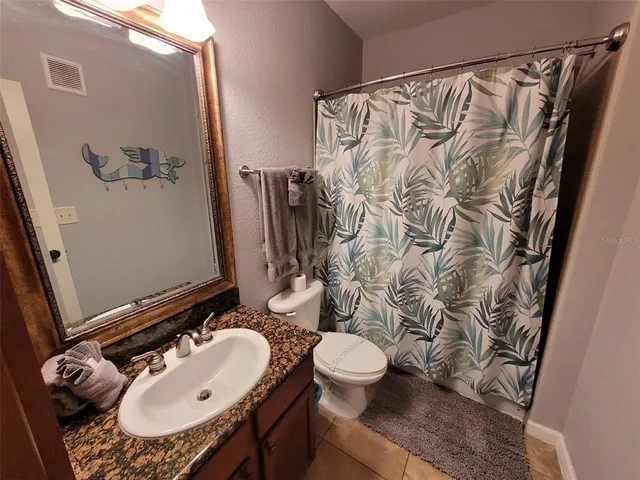 a bathroom with a sink and mirror with toilet