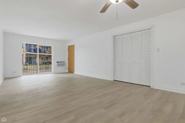 an empty room with chandelier fan