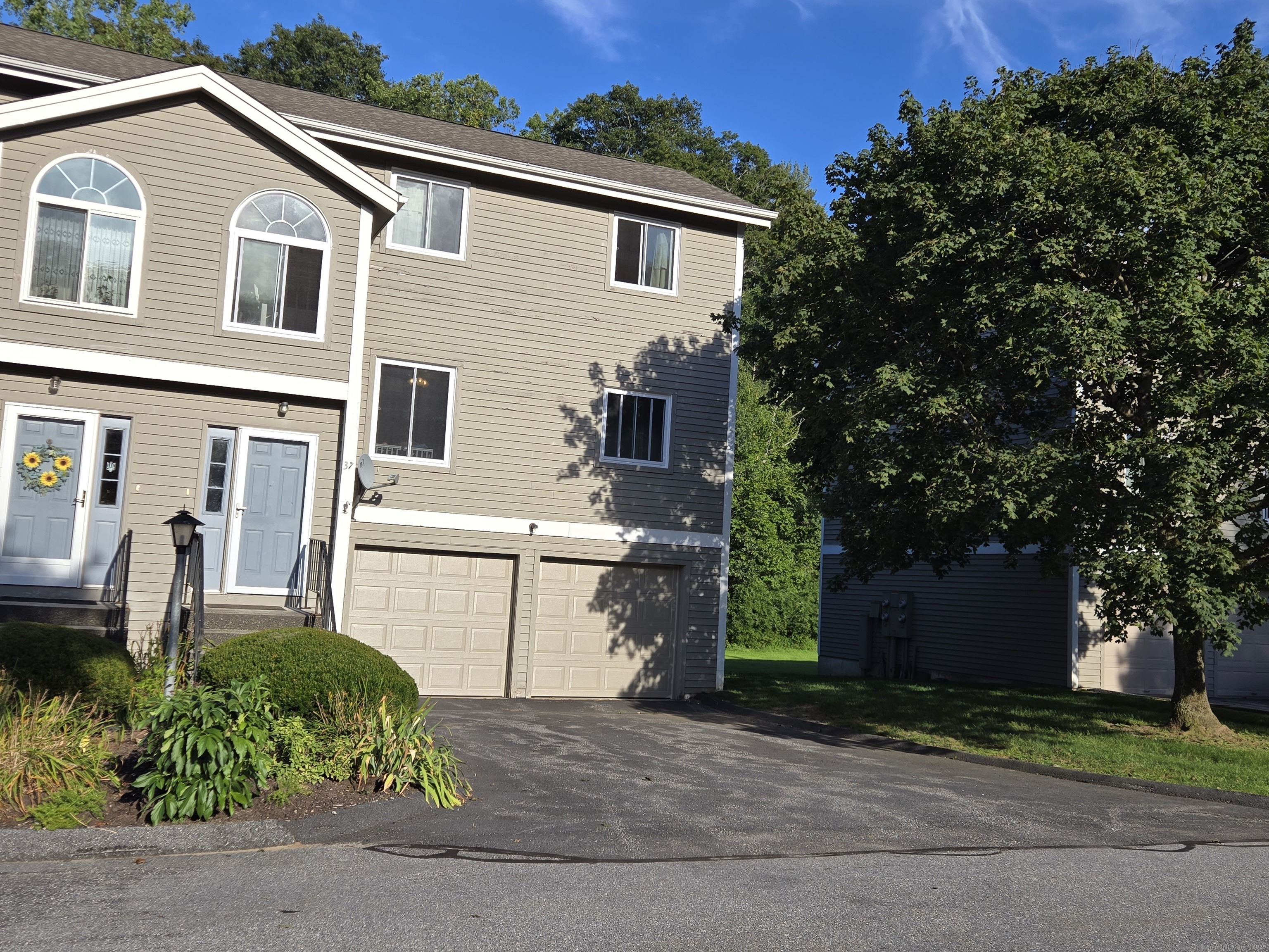 a front view of a house with garden