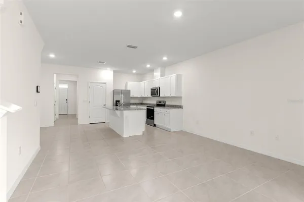 an empty room with sliding glass door and shower