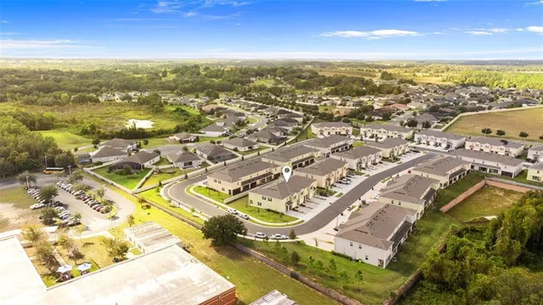 an aerial view of residential houses with outdoor space