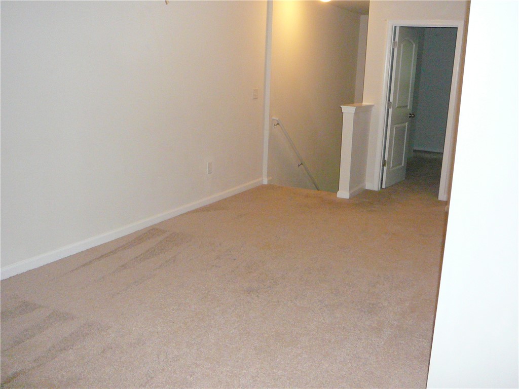 147 Evonshire Boulevard Anderson, SC 29621 - Photo 15 of 19 Warmly carpeted space with access to additional rooms and a descending staircase.