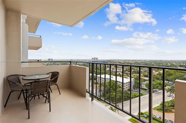 a view of a chair and table in the balcony
