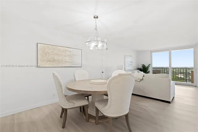 a dining room with furniture a rug and wooden floor