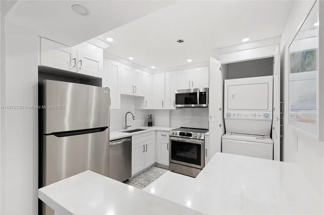 a kitchen with stainless steel appliances a refrigerator sink and stove