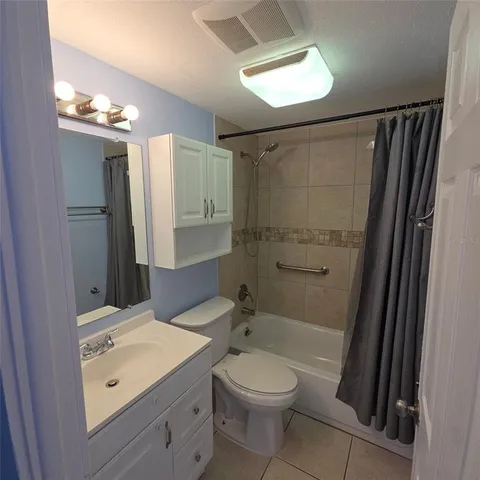 a bathroom with a toilet sink and shower