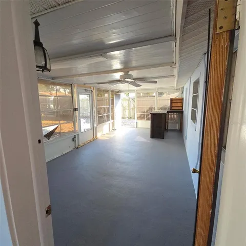 an empty room with windows and entrance