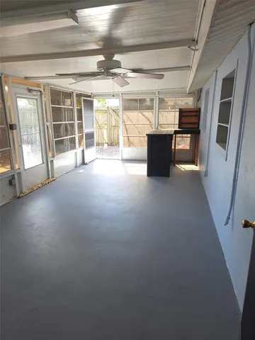 a view of empty room with a fan