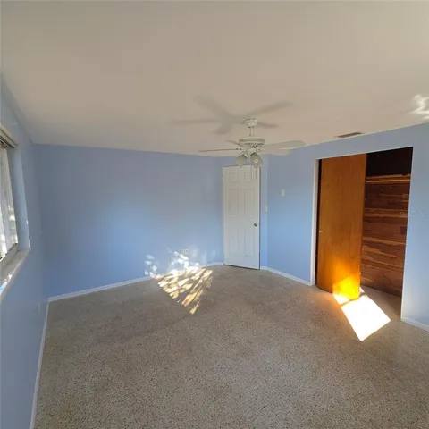 a view of small space with wooden floor and windows