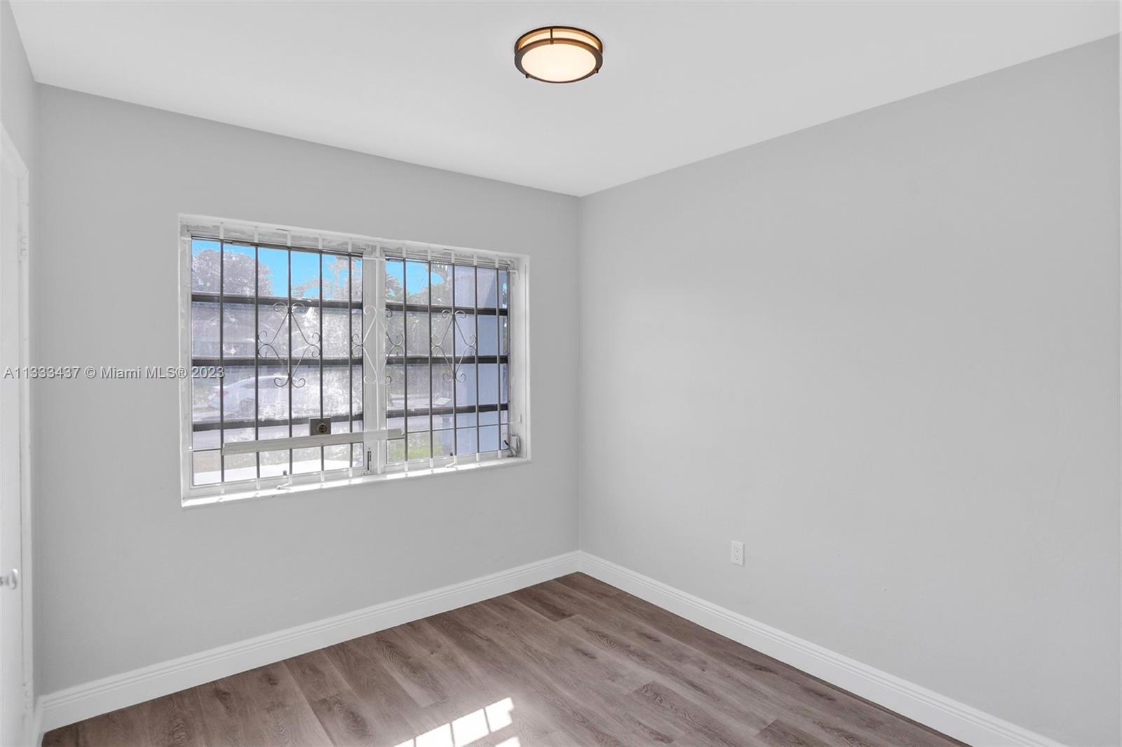 1101 Northwest 147th Street Miami, FL 33168 - Photo 14 of 45 an empty room with windows