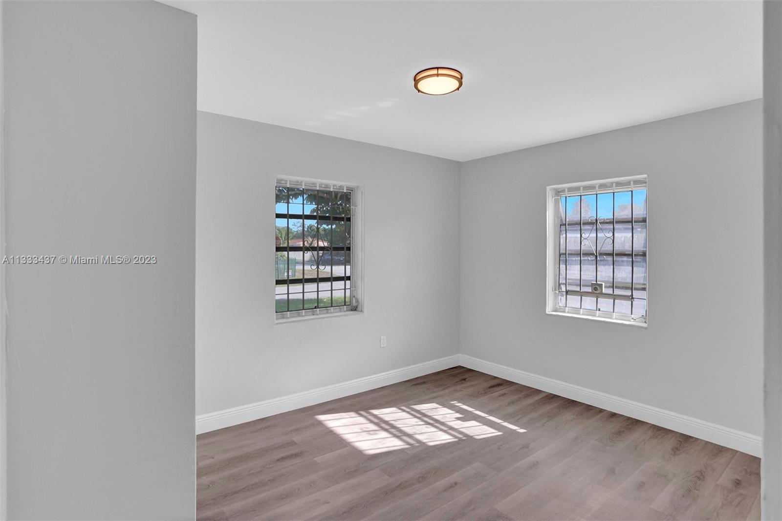 1101 Northwest 147th Street Miami, FL 33168 - Photo 18 of 45 an empty room with a window