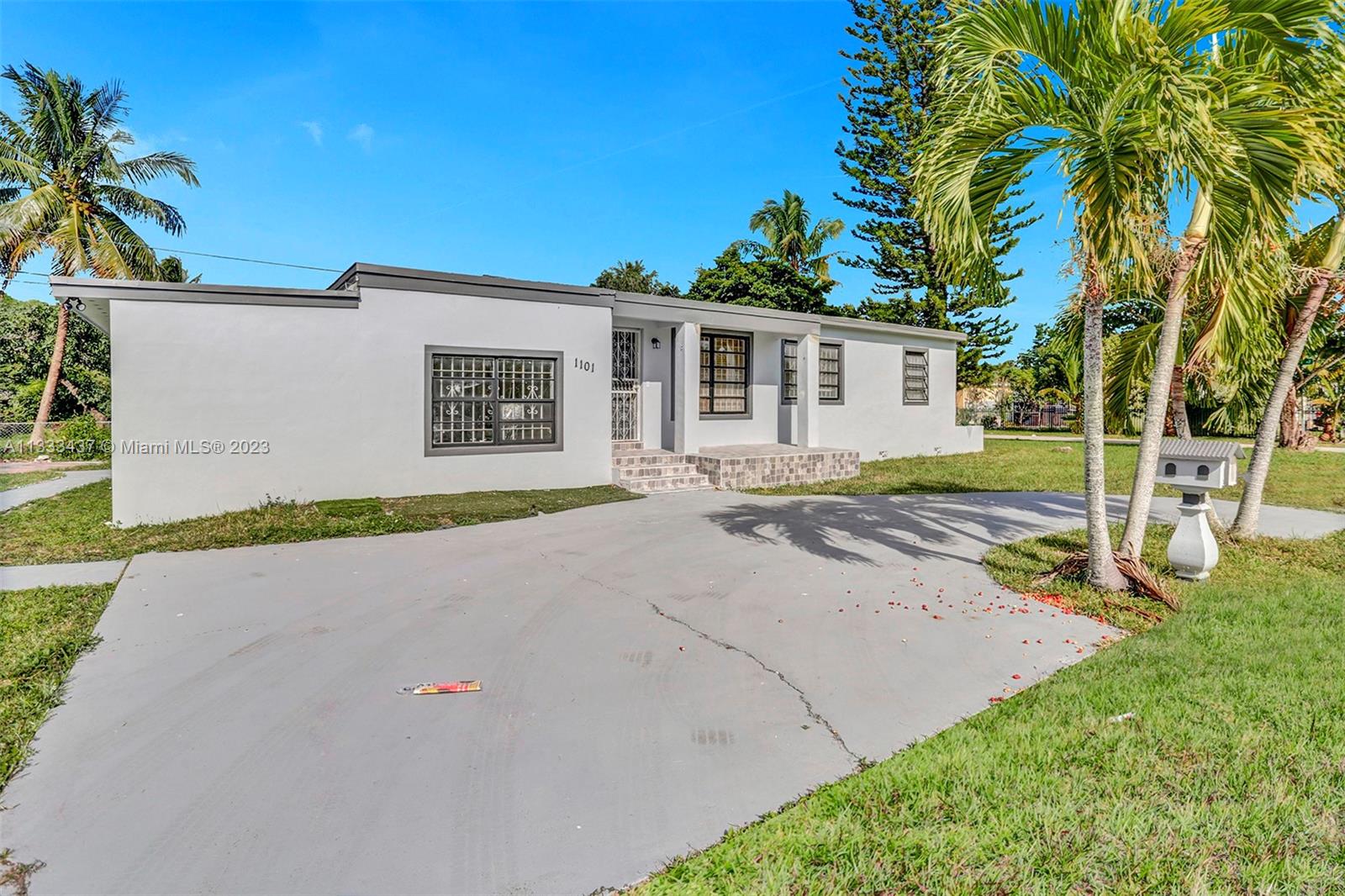 1101 Northwest 147th Street Miami, FL 33168 - Photo 2 of 45 a house with trees in front of it